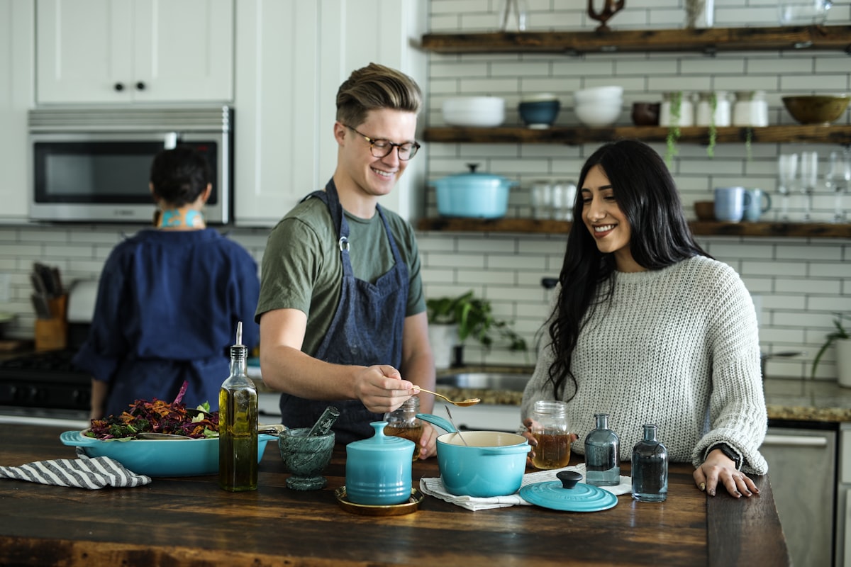 Chefs preparing food in a bright open kitchen.